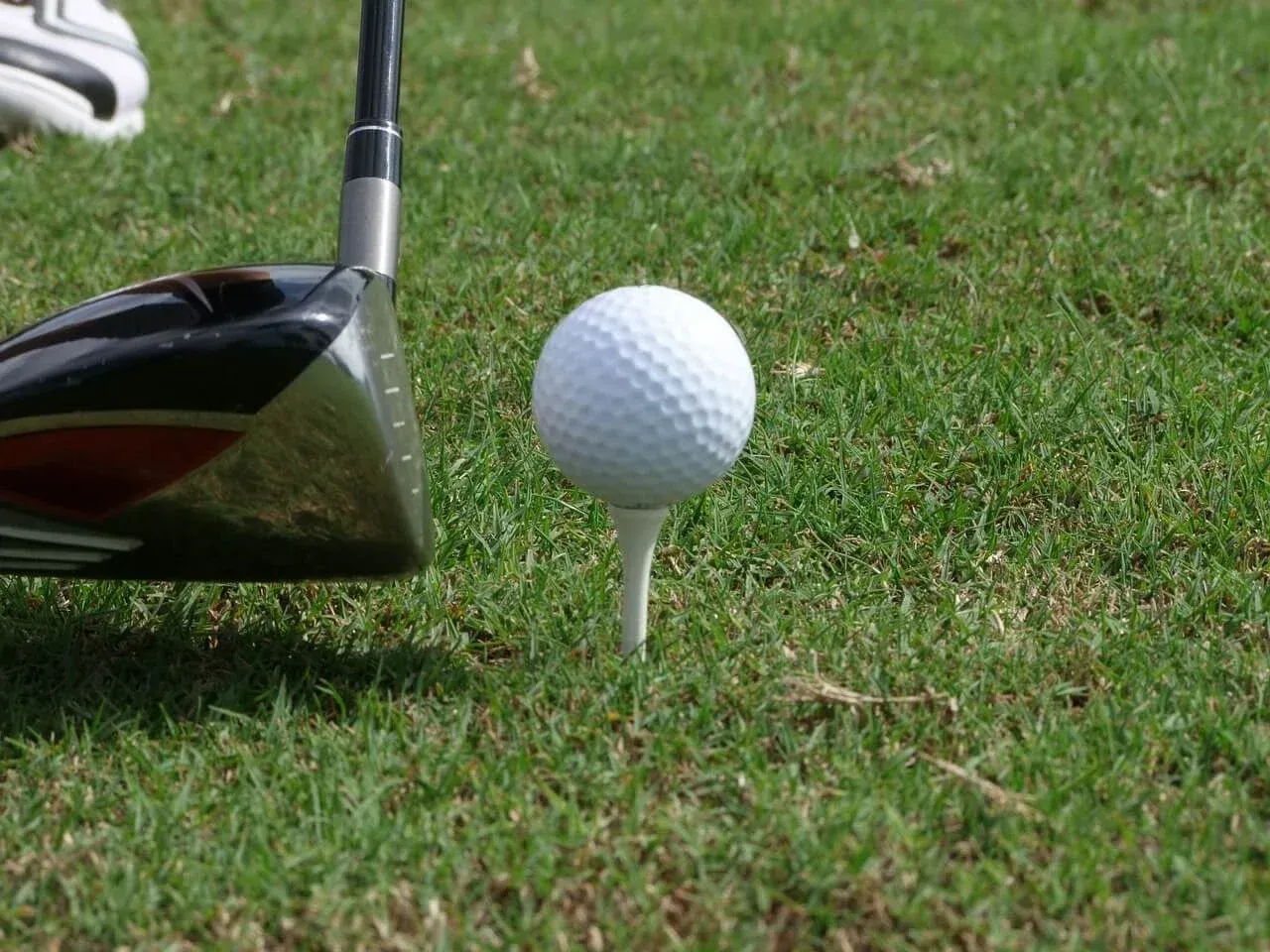 Golfer approaching ball with driver in a side view at Chiang Mai Gymkhana Club