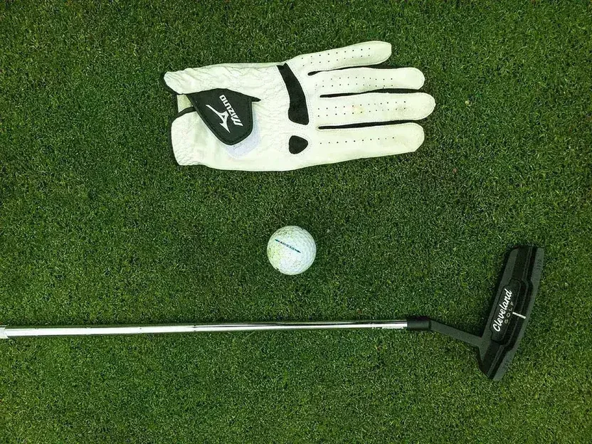 Golf flatlay showing a glove, ball, and putter at the Chiang Mai Gymkhana Club pro shop