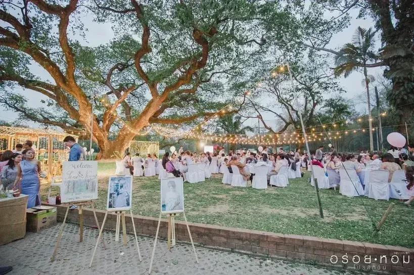 Large outdoor wedding reception at dusk at Chiang Mai Gymkhana