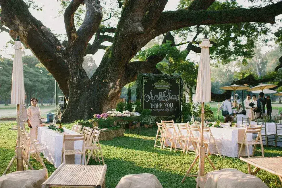 Rustic outdoor wedding setup with chalkboard at Chiang Mai Gymkhana